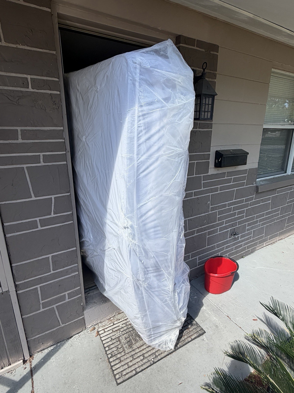King White Mattress in Protective Plastic Cover for Bedroom