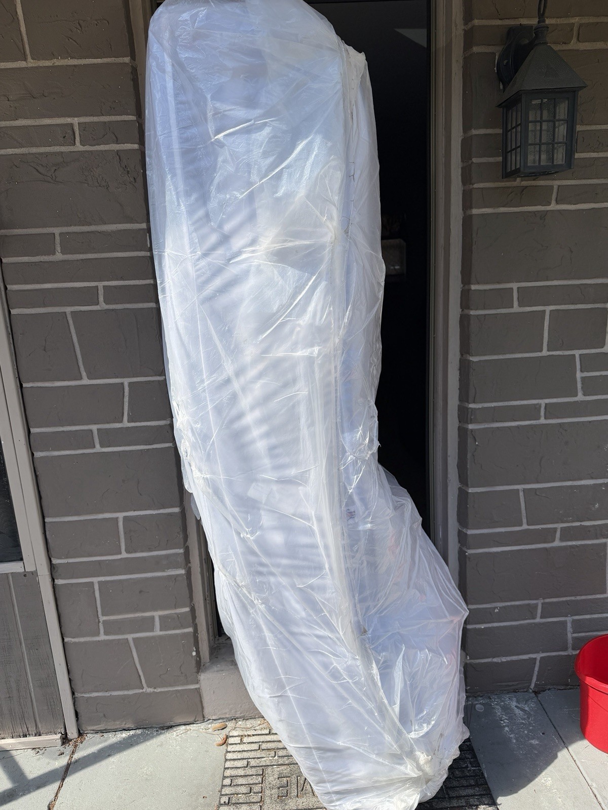 King White Mattress in Protective Plastic Cover for Bedroom