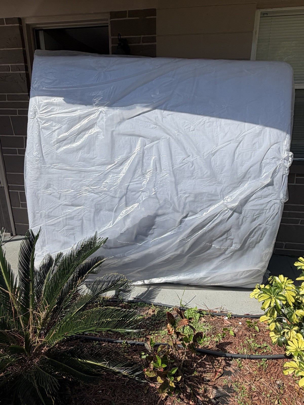 King White Mattress in Protective Plastic Cover for Bedroom