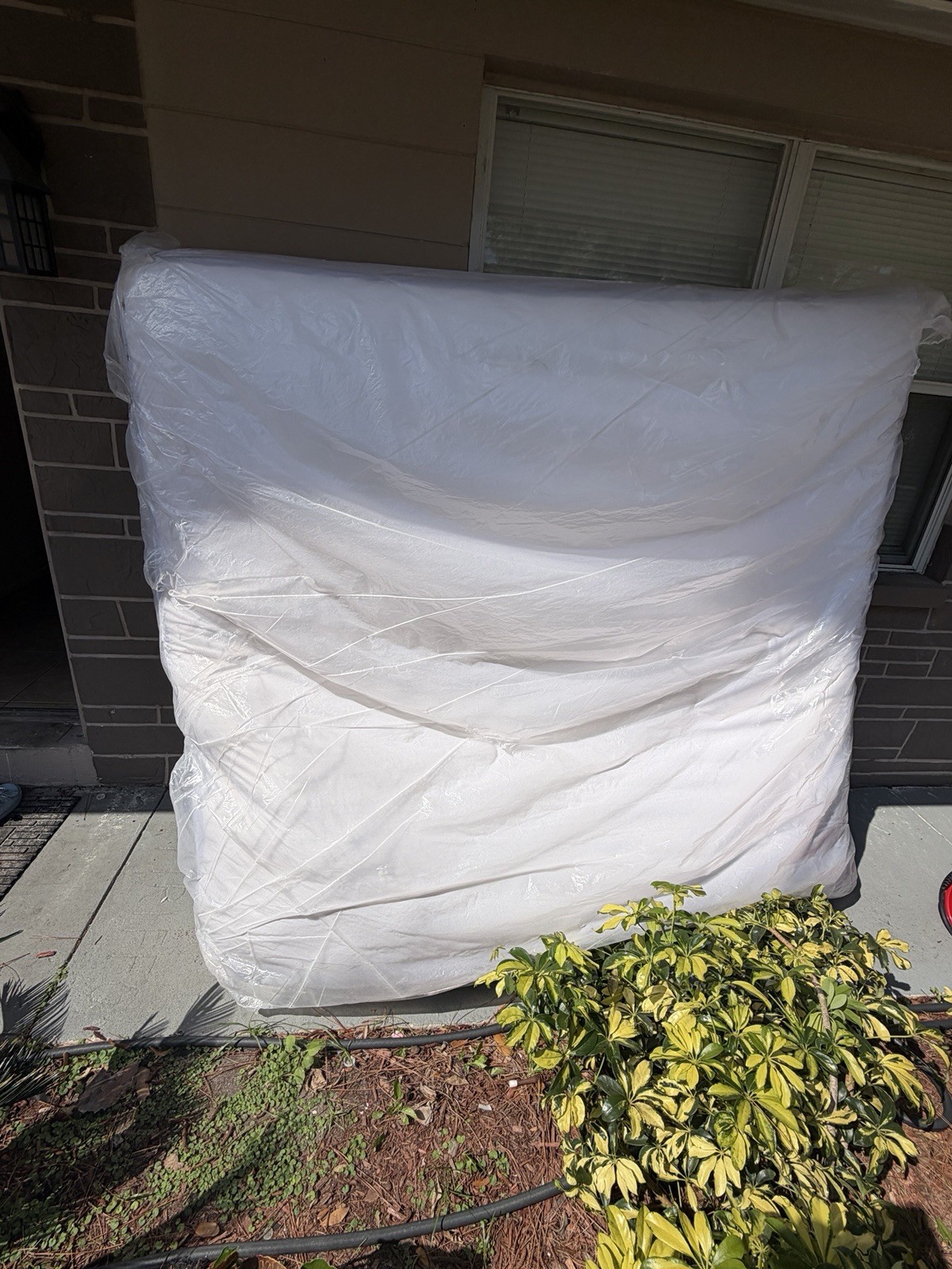 King White Mattress in Protective Plastic Cover for Bedroom