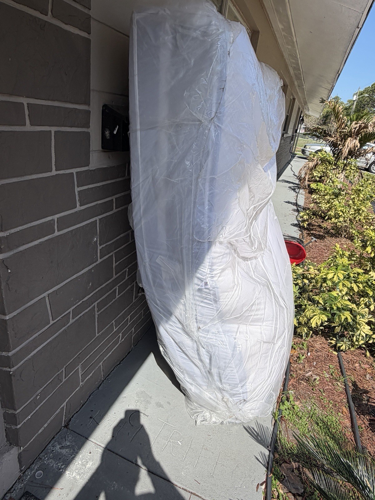 King White Mattress in Protective Plastic Cover for Bedroom