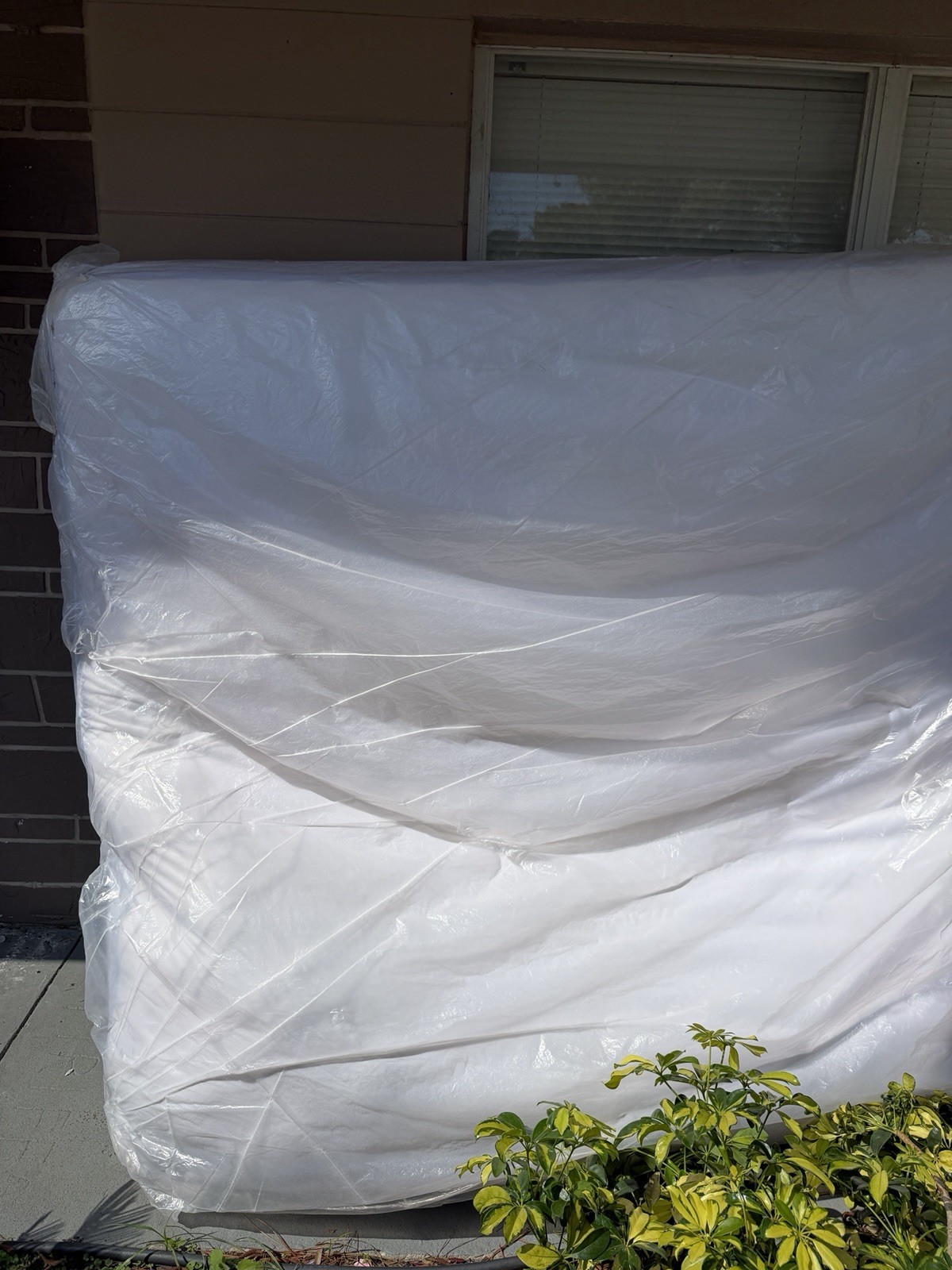 King White Mattress in Protective Plastic Cover for Bedroom