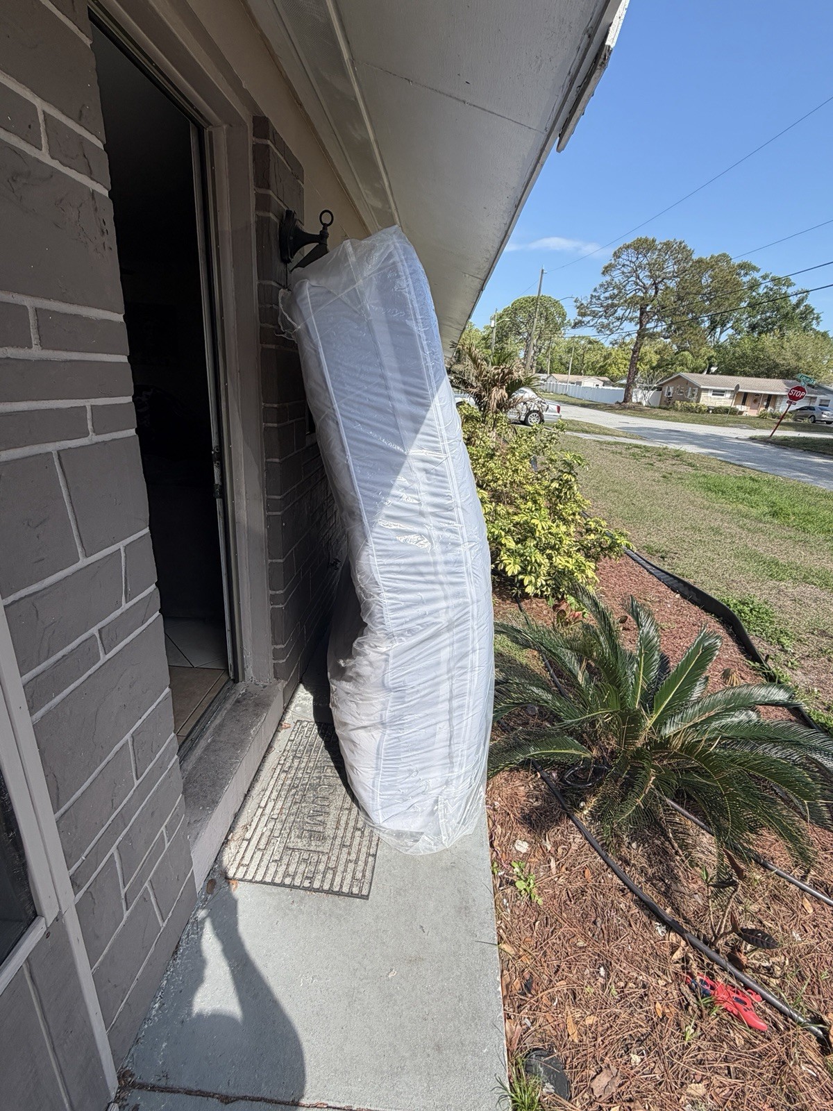 King White Mattress in Protective Plastic Cover for Bedroom