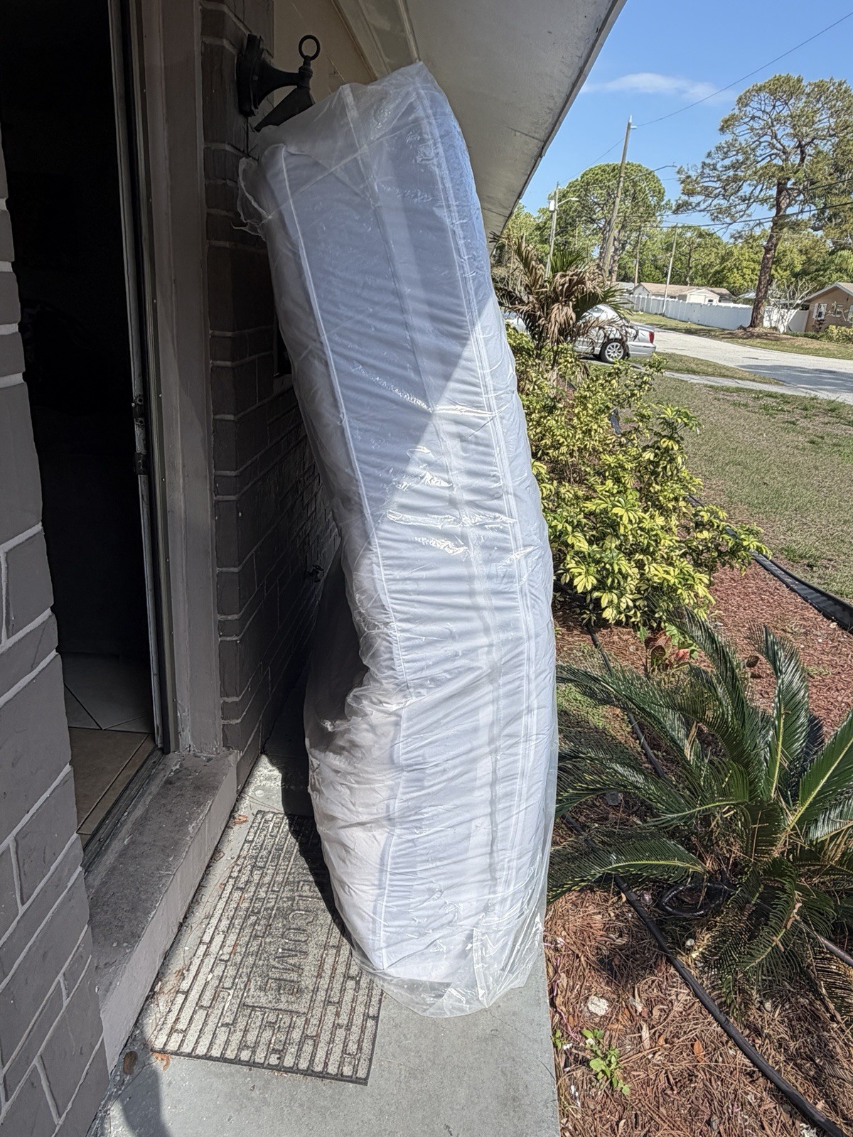 King White Mattress in Protective Plastic Cover for Bedroom