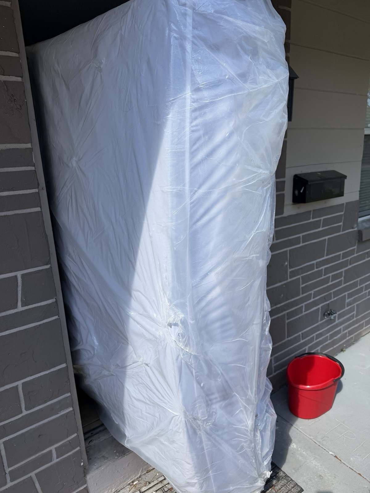 King White Mattress in Protective Plastic Cover for Bedroom