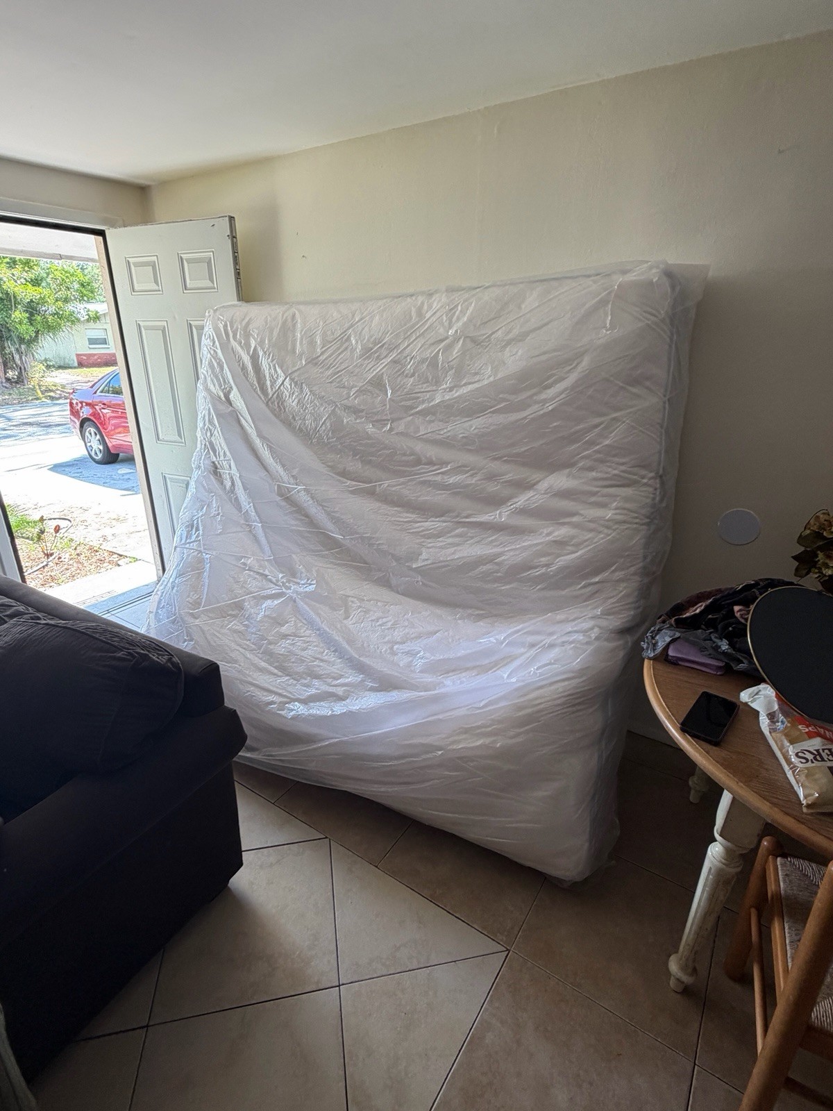 King White Mattress in Protective Plastic Cover for Bedroom